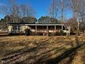 Single-wide manufactured home with covered porch and large yard at 165 Wakeline Dr, Wendell, NC 27591
