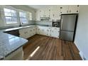 Renovated kitchen boasts granite countertops and stainless steel appliances at 209 Carolyn Dr, Benson, NC 27504