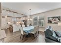 Kitchen and dining area with an island, stainless steel appliances, and hardwood floors at 212 War Admiral Dr, Clayton, NC 27520