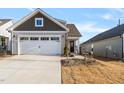 Two-story Craftsman style home with a two car garage and landscaped front yard at 212 War Admiral Dr, Clayton, NC 27520