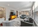 Spacious living room with leather sofas and large windows providing natural light at 212 War Admiral Dr, Clayton, NC 27520