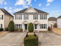 Two-story townhome with light beige siding, gray shutters, and a shared driveway at 2321 Turtle Point Dr, Raleigh, NC 27604