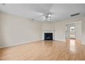 Living room with hardwood floors, fireplace, and ceiling fan at 2321 Turtle Point Dr, Raleigh, NC 27604