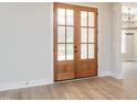The entryway features wood-look flooring, decorative glass double doors and modern lighting at 260 Ellington Rd, Graham, NC 27253