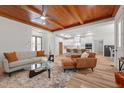 Spacious living room with a wood ceiling, a seamless transition to the kitchen, and sleek, stylish decor at 260 Ellington Rd, Graham, NC 27253