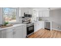 Modern white kitchen with stainless steel appliances and quartz countertops at 322 Pace St, Smithfield, NC 27577