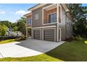 Contemporary two-story home with a two-car garage, wood and gray siding, and a balcony at 324 Waldo St, Cary, NC 27511