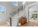 Modern staircase featuring wood steps, iron railings, and abundant natural light at 324 Waldo St, Cary, NC 27511