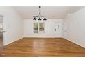 Bright dining room with hardwood floors and modern lighting at 3413 Thistledown Ct, Efland, NC 27243