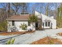 Charming exterior view of a modern home with unique architectural details and fresh, white siding with well-maintained landscaping at 5709 Russell Rd, Durham, NC 27712