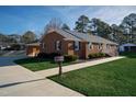Side view of brick ranch house, showcasing driveway and landscaping at 610 Denim Dr, Erwin, NC 28339