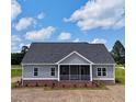 Charming one-story home featuring gray siding, brick foundation and a cozy screened-in front porch at 6294 River Rd, Fuquay Varina, NC 27526