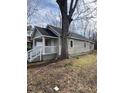 Side view of tan house with white porch and railing, large tree nearby at 715 Star St, Rocky Mount, NC 27804