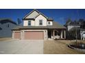 Two-story house with two-car garage and stone accents at 897 Golden Plum Ln, Zebulon, NC 27597