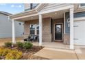 Brick front porch with seating area and access to the front door at 1007 Cherry Stem Rd, Haw River, NC 27258