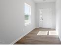 Bright entryway with beautiful wood-look floors and a large window at 104 Central Townes Way # 296, Raleigh, NC 27603