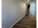 Hallway features luxury vinyl flooring and carpeted stairs at 107 Central Townes Way # 298, Raleigh, NC 27603