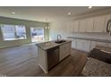 Modern kitchen with granite island and stainless dishwasher at 107 Central Townes Way # 298, Raleigh, NC 27603