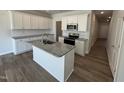 New kitchen with granite island and stainless appliances at 107 Central Townes Way # 298, Raleigh, NC 27603