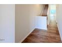Inviting entryway with wood floors and staircase leading to upper level at 111 Central Townes Way # 299, Raleigh, NC 27603