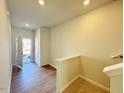 Bright foyer with hardwood floors, staircase and access to the front door at 111 Central Townes Way # 299, Raleigh, NC 27603