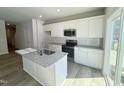 New kitchen with stainless steel appliances, granite counters, an island, and white shaker cabinets at 115 Central Townes Way # 300, Raleigh, NC 27603