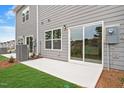 A concrete patio with gray siding and a sliding glass door offers outdoor space at 116 Fideaux Blvd # 258, Raleigh, NC 27603