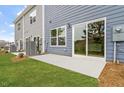 Home exterior features a patio with sliding glass doors and a well-maintained lawn at 120 Fideaux Blvd # 257, Raleigh, NC 27603