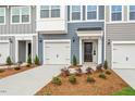 Well-maintained townhome with garage, landscaped yard and contemporary exterior lighting at 120 Fideaux Blvd # 257, Raleigh, NC 27603