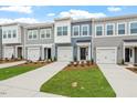 View of attractive townhomes showcasing modern design, individual garages, and manicured lawns at 120 Fideaux Blvd # 257, Raleigh, NC 27603
