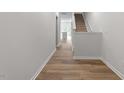 The entryway showcases the elegant staircase and leads to a welcoming interior space with wood floors at 124 Fideaux Blvd # 256, Raleigh, NC 27603