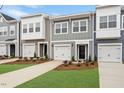 Charming townhomes featuring attached garages, tidy lawns, and welcoming front entries at 124 Fideaux Blvd # 256, Raleigh, NC 27603
