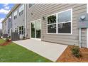 Backyard patio with sliding glass doors and gray siding provides an ideal outdoor retreat at 128 Fideaux Blvd # 255, Raleigh, NC 27603