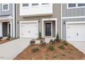 The townhome with welcoming front door is complemented by a manicured landscape at 128 Fideaux Blvd # 255, Raleigh, NC 27603
