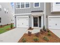 Attractive townhome featuring an individual garage, a well-kept lawn, and pleasing neutral color schemes at 132 Fideaux Blvd # 254, Raleigh, NC 27603