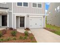Up close exterior of townhome featuring a garage and walkway with fresh landscaping at 136 Fideaux Blvd # 253, Raleigh, NC 27603