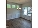 Dining room with stylish chandelier and natural light from the large windows at 142 Vega Loop, Sanford, NC 27330