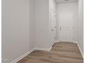 A well-lit entryway displays a white door, hardwood floors, and neutral wall paint at 144 Fideaux Blvd # 251, Raleigh, NC 27603
