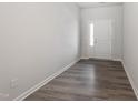 Inviting foyer with wood-look floors and a white front door with glass sidelight at 148 Fideaux Blvd # 250, Raleigh, NC 27603