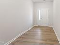 Entry foyer with wood flooring and white door featuring sidelight at 152 Fideaux Blvd # 249, Raleigh, NC 27603