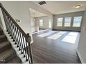 Open floor plan with wood floors connecting the stairs and living area at 154 Vega Loop, Sanford, NC 27330