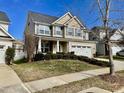 Two-story house with a neutral color scheme and a landscaped front yard at 1936 Sinclair Trce, Burlington, NC 27215
