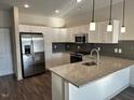 Modern kitchen with stainless steel appliances and granite countertops at 2225 Gathering Square Ct # 2225, Fuquay Varina, NC 27526