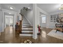 Bright entryway boasts hardwood floors and staircase leading upstairs at 3308 Eden Grove Rd, Fuquay Varina, NC 27526