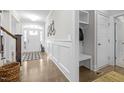 Light-filled foyer features crisp white trim and wainscoting with hardwood floors at 3308 Eden Grove Rd, Fuquay Varina, NC 27526