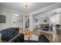 Elegant living room featuring hardwood floors, decorative trim, modern lighting, and stylish furnishings at 3308 Eden Grove Rd, Fuquay Varina, NC 27526