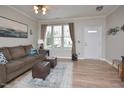 Bright living room with hardwood floors and a view of the front door at 4847 Sir Duncan Way, Raleigh, NC 27612