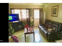 Living room with leather couch, coffee table, and Christmas tree at 512 E Branch St, Spring Hope, NC 27882