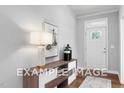 Charming foyer featuring a white front door, light-colored walls, and elegant decor at 54 Cultivator Ct, Angier, NC 27501
