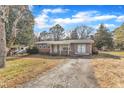 Ranch home with a gray exterior, and a paved driveway at 704 Sunnybrook Rd, Raleigh, NC 27610